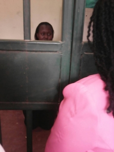 Margaret Kadama breathing behind Entebbe Magistrate court cells on Friday.
