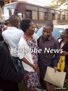 A relative (right) hugs Sylivia Kirabo shortly after walking out of Entebbe court cells.